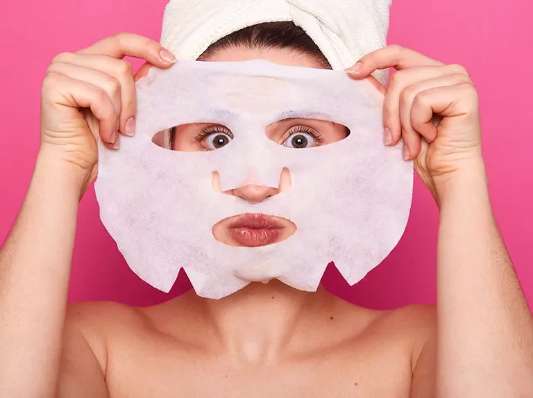Woman with white sheet mask, facial treatment, skincare routine, spa day, beauty regimen, towel on head, close-up portrait, skincare and beauty concept, rejuvenation, relaxation, pampering